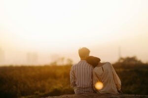 man and woman near grass field