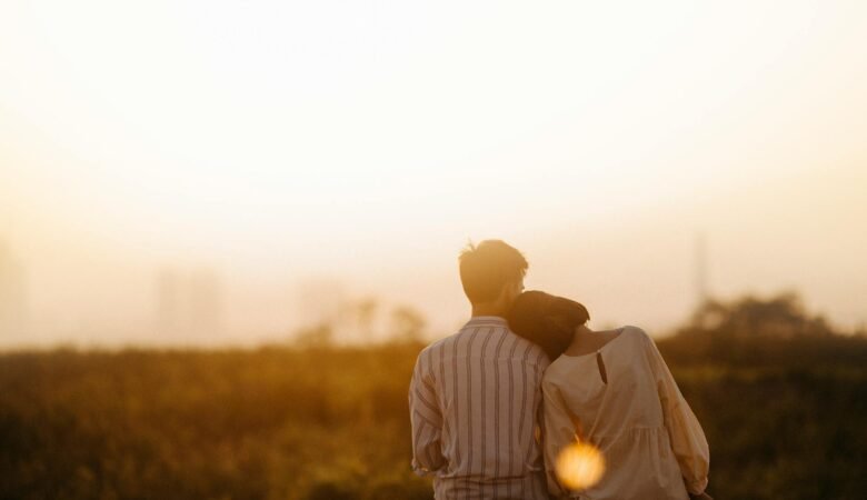 man and woman near grass field